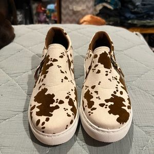 Cow print slip ons